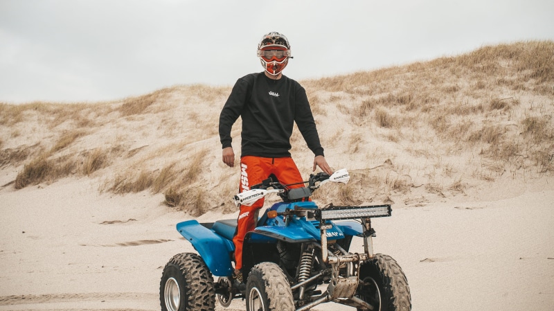 beach, sand, racing, apparel, nature, person, vehicle, wheel, land, dust, vacations, quad, one person, riding, blue, sport, savage, transportation, sports helmet