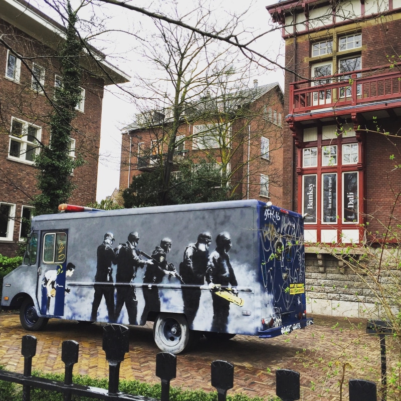 tourism, mode of transportation, bare tree, street, plant, outdoors, work, illustration, building exterior, pop-art, design, banksy, mural, built structure