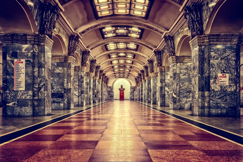incidental people, walking, metro station, one person, direction, tiled floor, architectural column, st petersburg, rear view, lifestyles, stop, the way forward