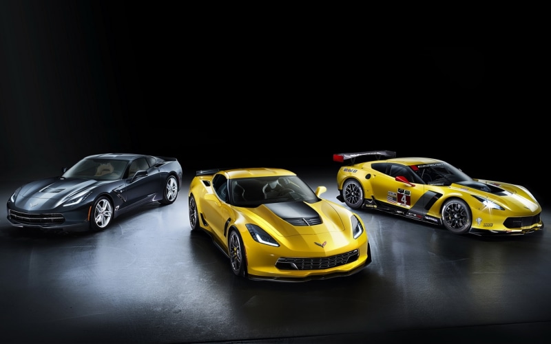 yellow, c, studio shot, in a row, still life, car, toy car, black background, professional sport, three, sport, C7.R GT2, colored, assorted, mode of transportation