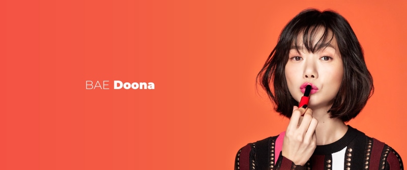studio shot, human body part, bangs, indoors, headshot, hair, hairstyle, child, red, Doona Bae, celebrity, adult, colored background, 2K, Sense 8, teenager