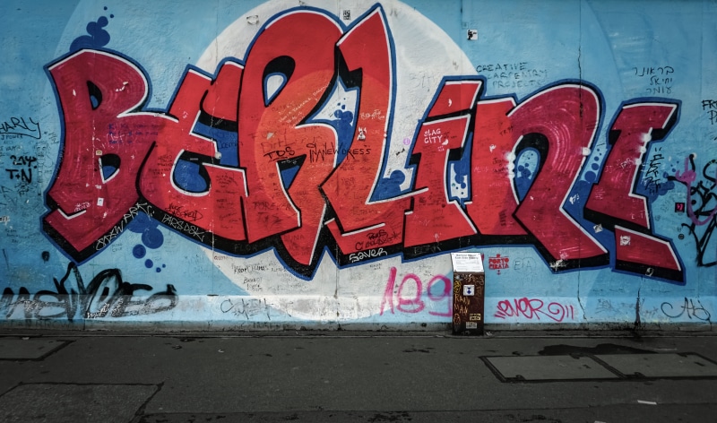 transportation, clothing, shipping container, wall - building feature, art and craft, painted, street art, day, creativity, tower, western script, outdoors