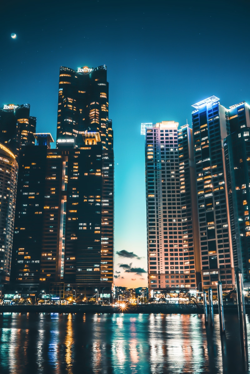 building exterior, cityscape, tower, modern, busan, tall - high, financial district, outdoors, illuminated, moon, built structure, stars, sunset, office building exterior