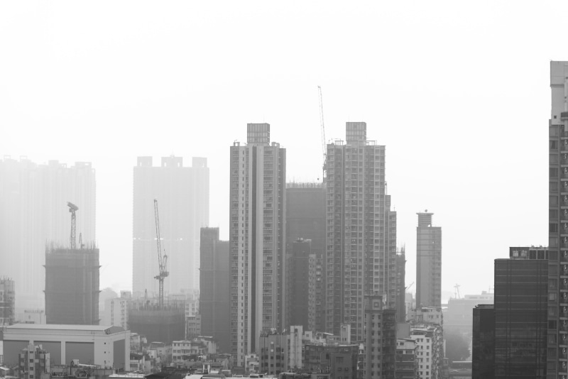 view, clear sky, urban skyline, office building exterior, settlement, built structure, city, black and white, skyscraper, high rise, outdoors, smog, hong kong