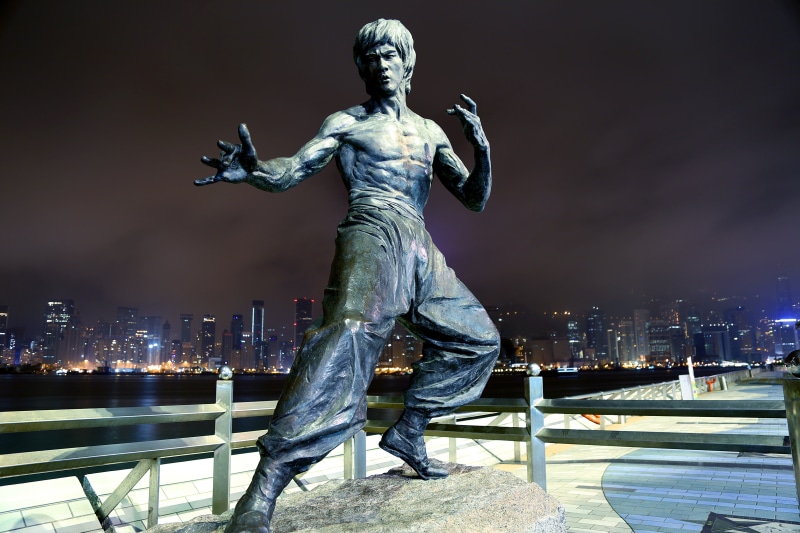 people, human representation, male likeness, architecture, nature, city, cityscape, built structure, background, sky, Bruce Lee, statue, night, representation