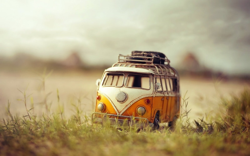 field, nature, volkswagen, yellow, retro styled, mode of transportation, car, bus, kombi, sky, outdoors, land vehicle, background, no people, travel, land
