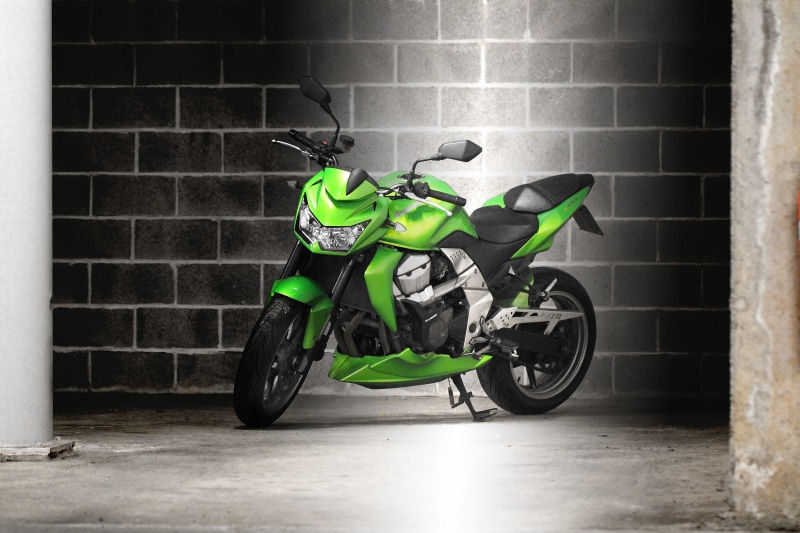 mode of transportation, z750, side view, wall - building feature, men, on the move, green, motorcycle, parked, headwear, helmet, garage, full length, brick wall