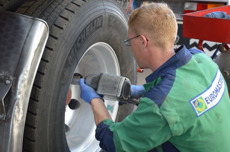 repairing, waist up, manufacturing equipment, people, work, skill, land Vehicle, tire, adult, mode of transportation, examining, males, one person, wheel