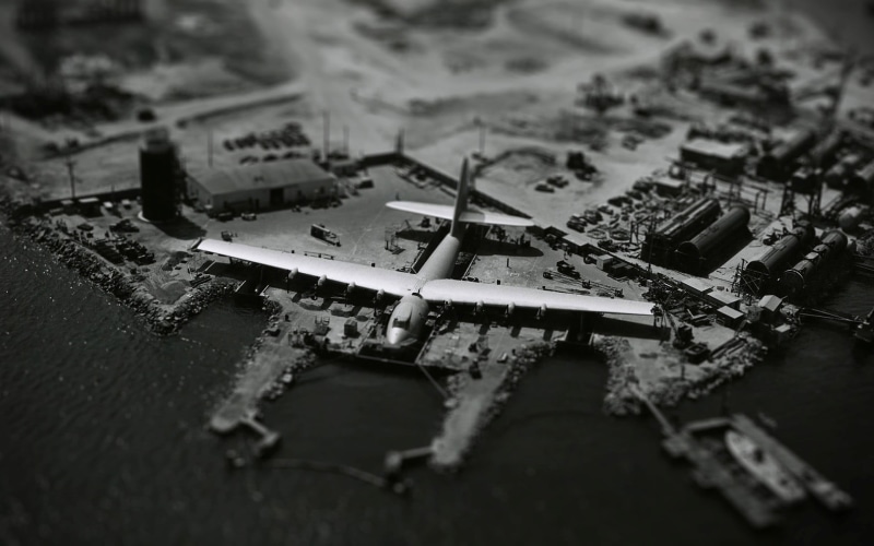 macro, 1080P, abandoned, tilt shift, destruction, damaged, outdoors, built structure, high angle view, aircraft, Hughes HK-1 Hercules, airline, close-up