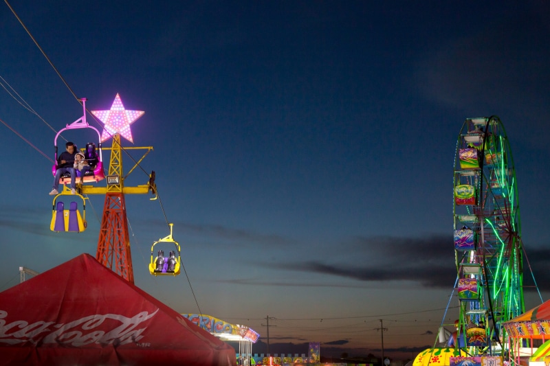motion, outdoors, nightlights, mexico, multi colored, family, ferris wheel, sky, amusement park, building exterior, night, carnival, low angle view, illuminated