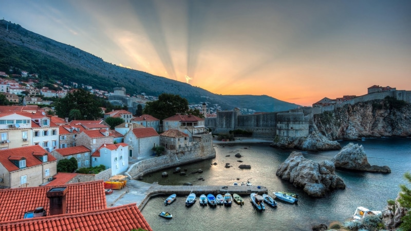 no people, city, water, cityscape, sunset, building, transportation, boats, built structure, high angle view, mountain, sea, nature, europe, sunray, sky