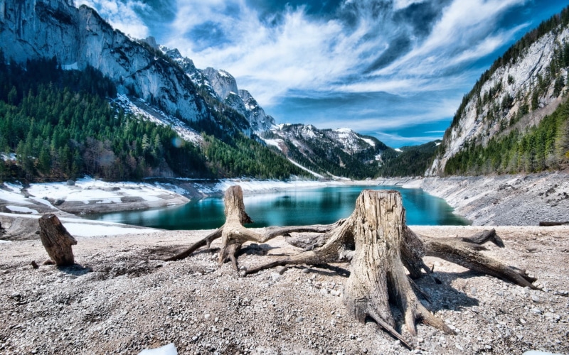 ice, day, tranquility, lake, outdoors, snowcapped mountain, non-urban scene, no people, sky, turquoise colored, wood - material, tree, cold temperature