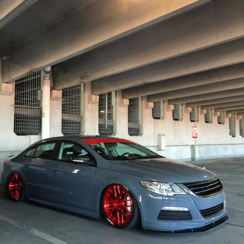 motion, motor vehicle, outdoors, road, architecture, tuning, mode of transportation, luxury, red, land vehicle, concrete, vehicle, Stance, wealth, sports car