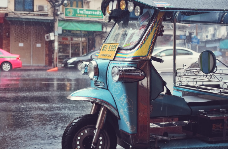 wet, taxi, mirror, tuktuk, parked, sidewalk, auto, store, road, stationary, city, bike, season, car, city street, blue, mode of transportation, building exterior