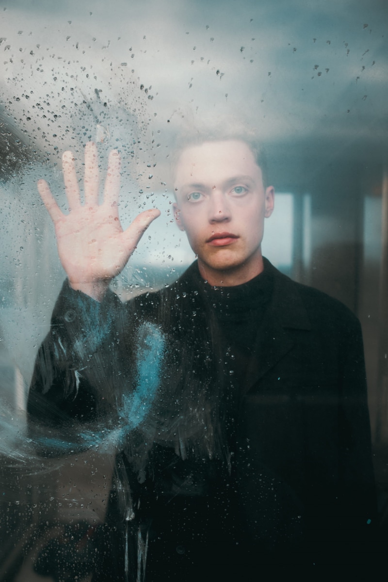 sad, human hand, looking at camera, front view, glass, indoors, rain, striking, young adult, glass - material, blue eye, portrait, jacket, depressed, putting