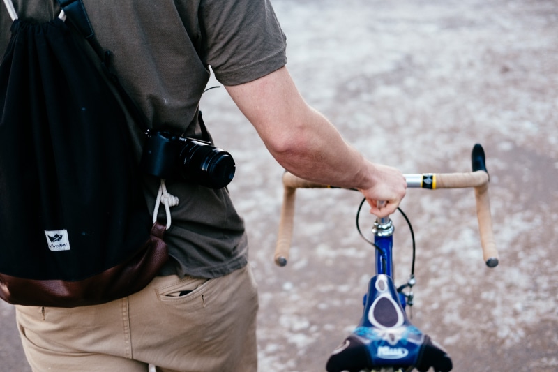 outdoor, road, standing, human body part, walking, focus on foreground, outdoors, cycling, human limb, holding, black, people, lifestyles, casual clothing