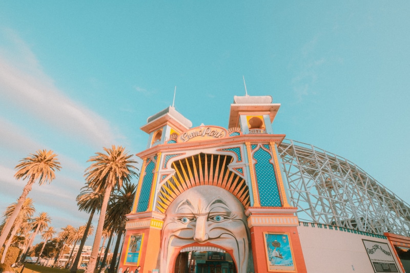 place of worship, architecture, rollercoaster, built structure, building exterior, city, sunlight, luna park, palm tree, low angle view, outdoors, amusement park