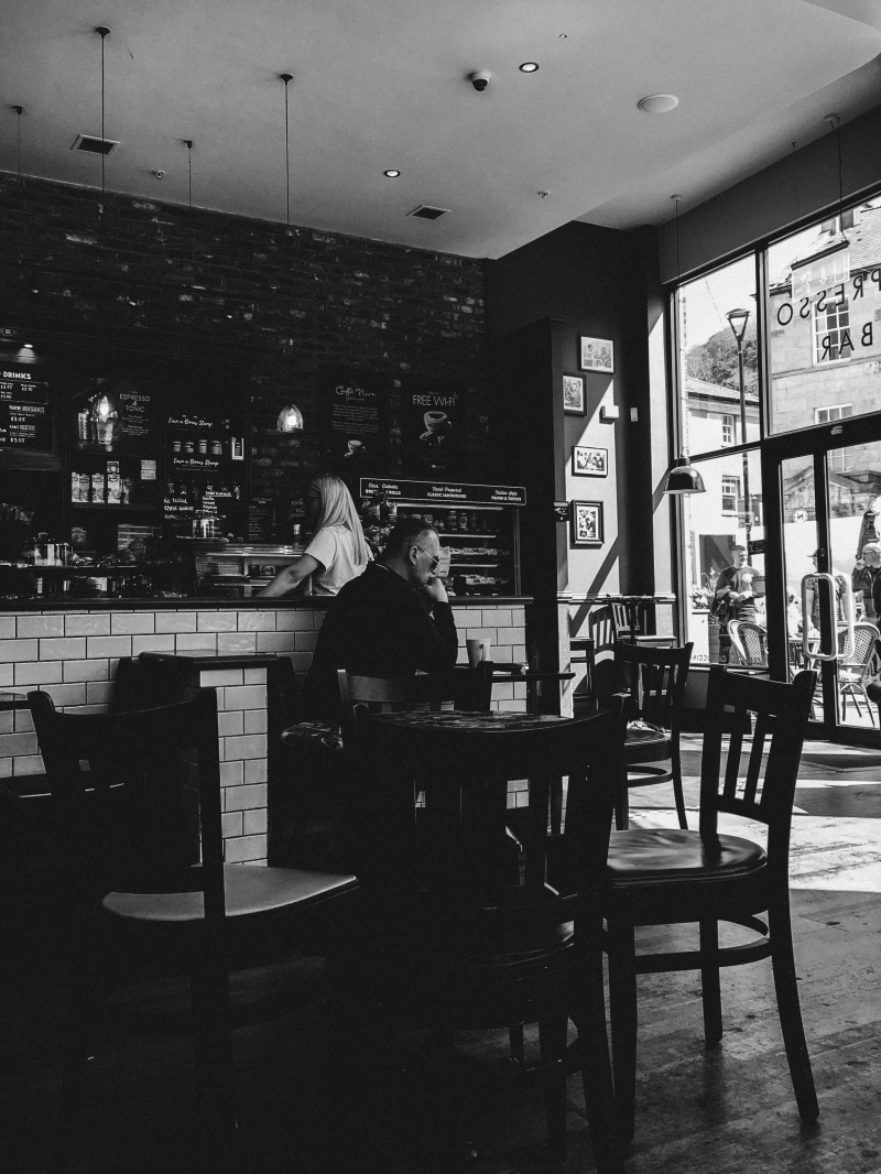 seats, built structure, bar cafe, architecture, men, lifestyles, cafe, leisure activity, chairs, cup, communication, people, wear, bar counter, one person