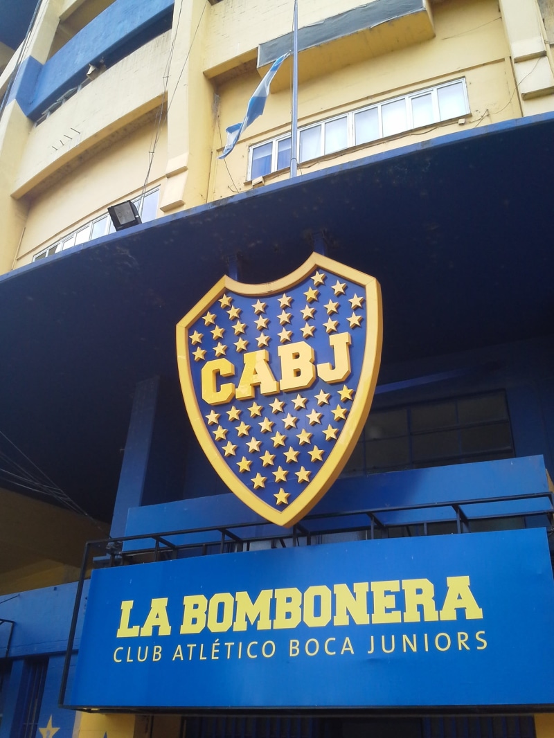 sign, no people, yellow, outdoors, information, stadium boca juniors, it bombonera, built structure, script, western script, day, building exterior, architecture