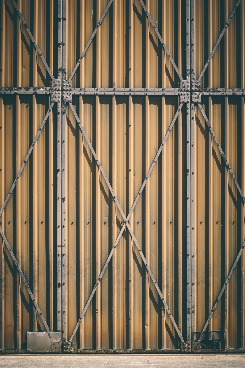 gray, protection, hangar door, low angle view, outdoors, natural, garage door, no people, steel, design, metal, hangar, wood - material, architecture, close-up