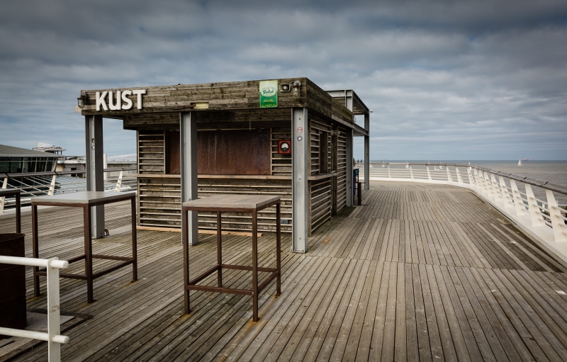 text, horizon, building, wood, shack, horizon over water, floor, tables, western script, day, water, scheveningen, built structure, kiosk, netherlands