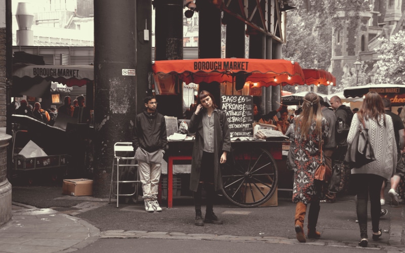 non-western script, wheel, kiosk, transportation, pedestrian, women, people, architecture, winter, england, city life, clothing, shoe, city, script, lifestyles