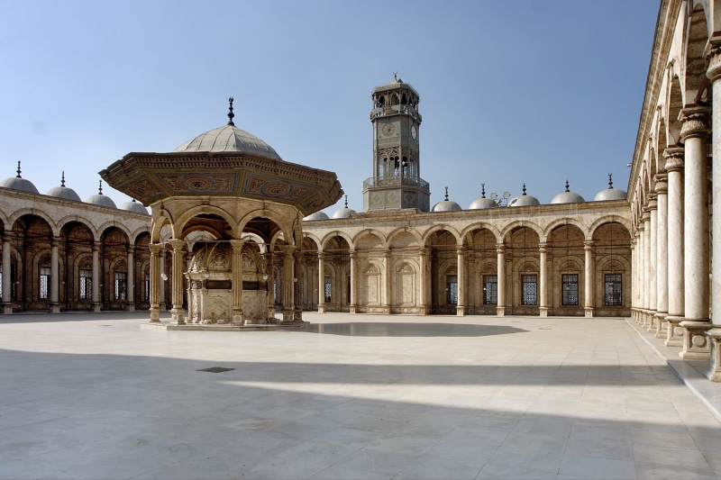 day, mosque, belief, arch, spirituality, architectural column, place of worship, sky, sunlight, travel destinations, nature, clear sky, colonnade, courtyard