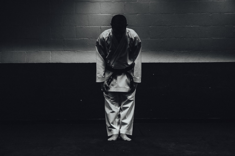 hood - clothing, depression - sadness, sports, one person, blackbelt, martial arts, clothing, 5K, day, men, karate, real people, graduation, wall - building feature