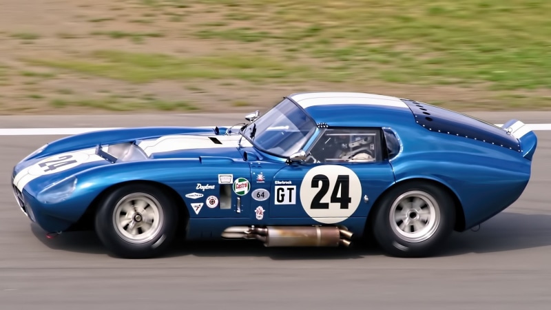 convertible, coupe, 1080P, outdoors, mode of transportation, car, number, nature, land vehicle, toy, focus on foreground, motion, close-up, Shelby Cobra Daytona