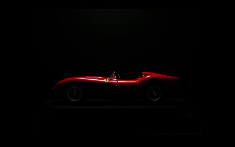 retro styled, motor vehicle, close-up, black background, land vehicle, transportation, single object, studio shot, dark, toy, Ferrari, indoors, red, mode of transportation