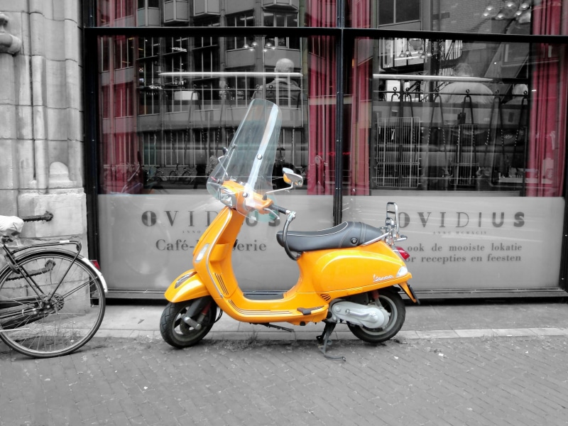 land vehicle, outdoors, motor, vehicle, transportation, 4K, car, city, yellow, mode of transportation, black, motor scooter, text, scooters, built structure