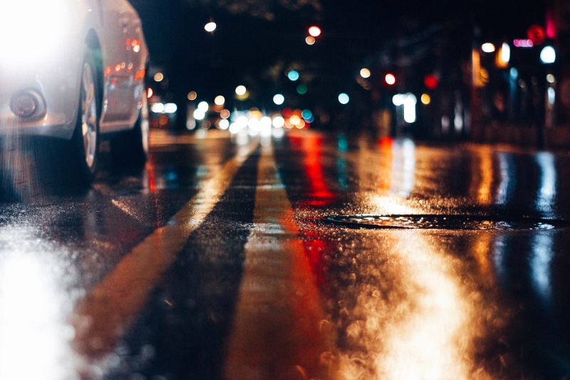 city street, drop, land vehicle, illuminated, traffic, light, nightlife, headlight, car, night, street light, wet, outdoors, background, no people, city