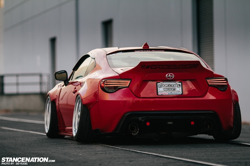 toy, street, black, city, 720P, Scion FR-S, land vehicle, mode of transportation, no people, sign, motor vehicle, road, text, Scion, red, outdoors, built structure