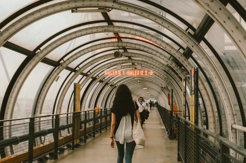 architecture, tunnel, wearing, human, banister, pants, arch, paris, ceiling, walkway, real people, footbridge, jeans, urban, centre de pompidou, women