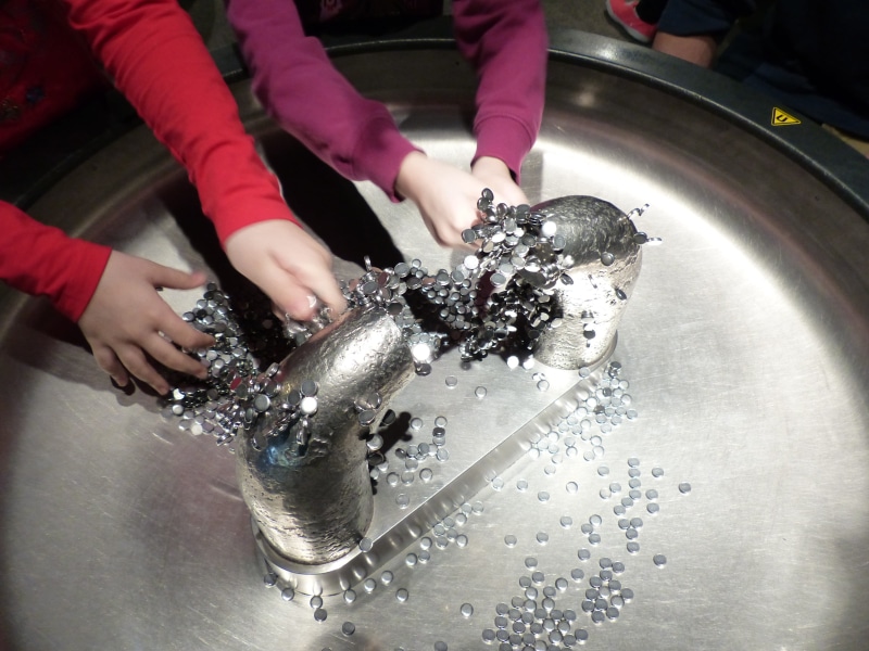 human body part, splashing, silver, silver colored, finger, museum, indoors, one person, holding, 4K, human hand, magnetism, running water, motion, lifestyles