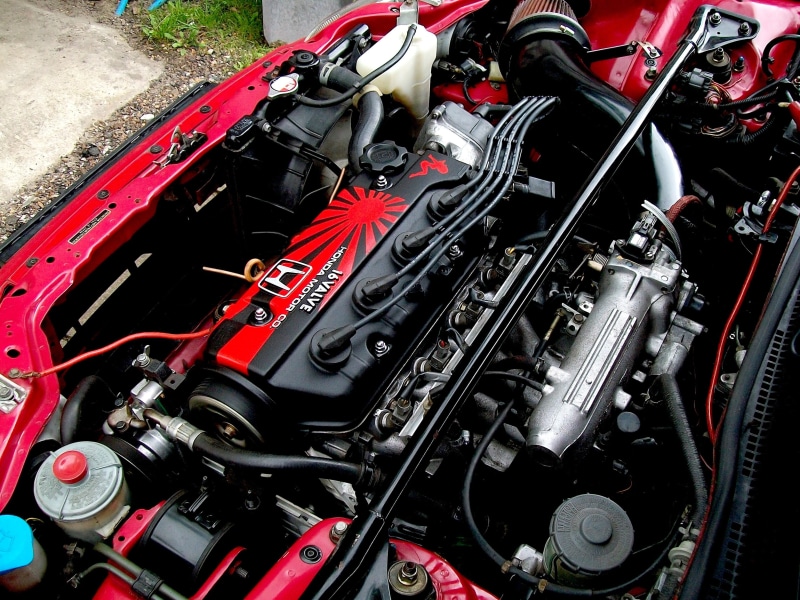 high angle view, 2K, close-up, day, red, bay, engines, Honda, outdoors, vehicle part, technology, machine part, transportation, motor vehicle, stationary