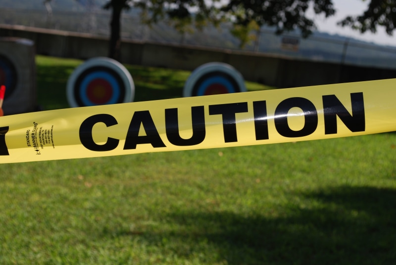 western script, sign, risk, yellow, tape, safety, land, warning sign, caution, field, careful, crime scene, text, outdoors, cordon tape, security, nature