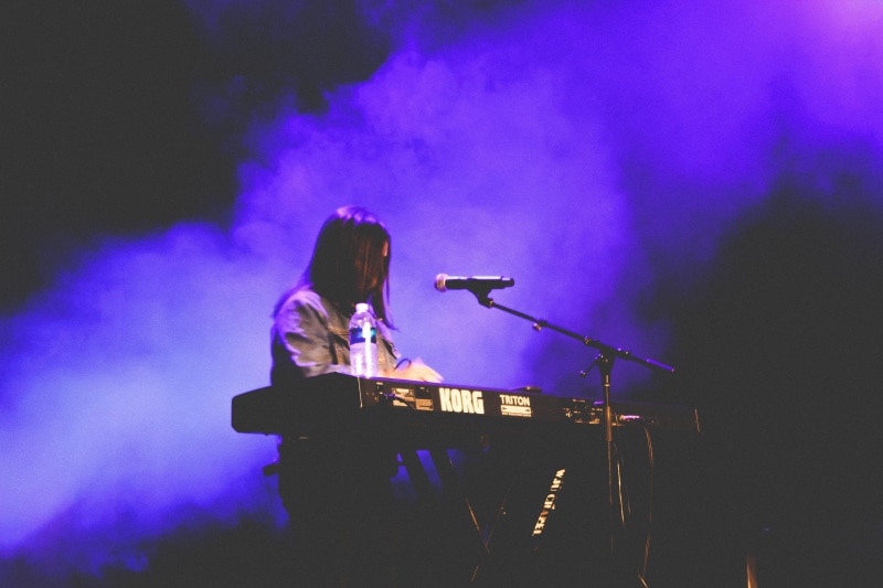 microphone, rock music, purple, music, skill, haze, leisure activities, electrical device, human, popular music concert, girl, artist, concert, musical equipment
