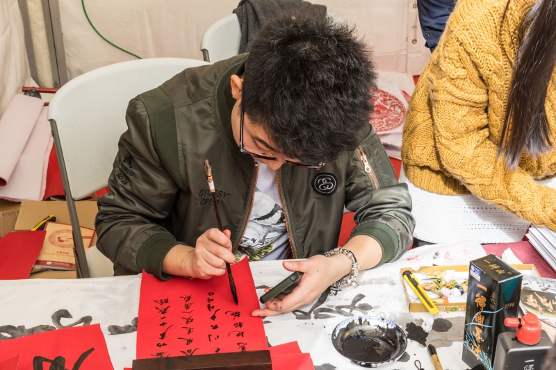 people, men, front view, creativity, looking down, writing, women, concentration, to write, clothing, characters, ideograms, paper, drawing - activity