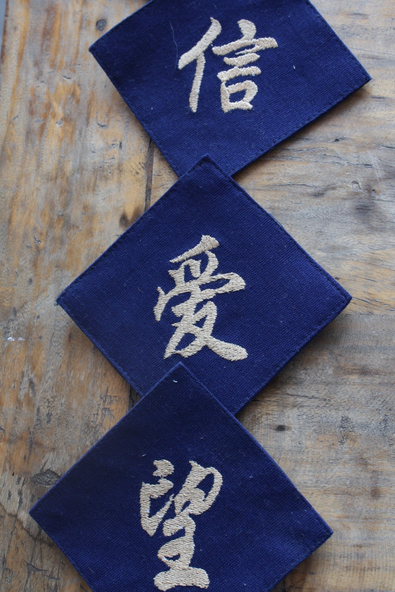 text, close-up, non-western script, communication, wood - material, writing, table, blue, directly above, calligraphy, indoors, script, no people, shape