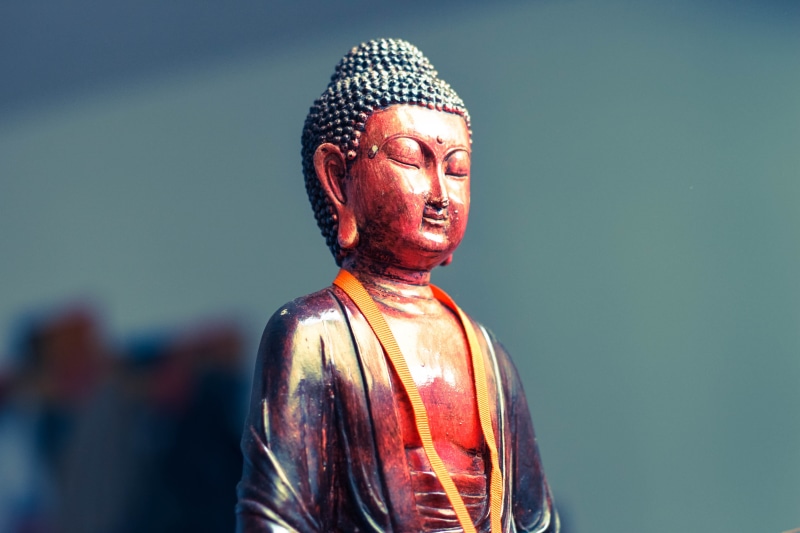 black, statue, single object, eastern, art and craft, focus on foreground, close-up, asia, sculpture, red, spirituality, male likeness, creativity, no people