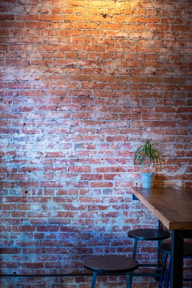 flower pot, growth, beside, scale, day, table, building, furniture, desk, pasadena, nature, architecture, plant, chair, wall, no people, texture, dining