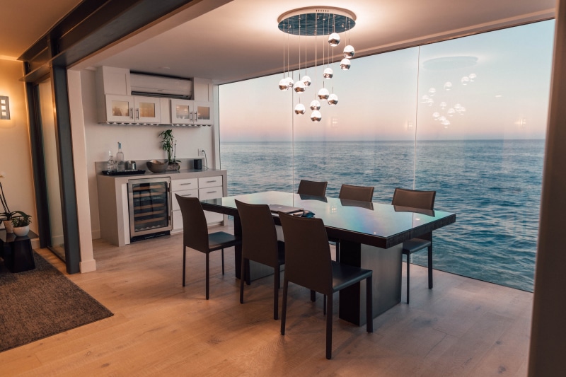 indoors, flooring, furniture, glass, sea, beside, oven, illuminated, set, interior, modern, seat, lighting equipment, table, chair, dining, electrical device
