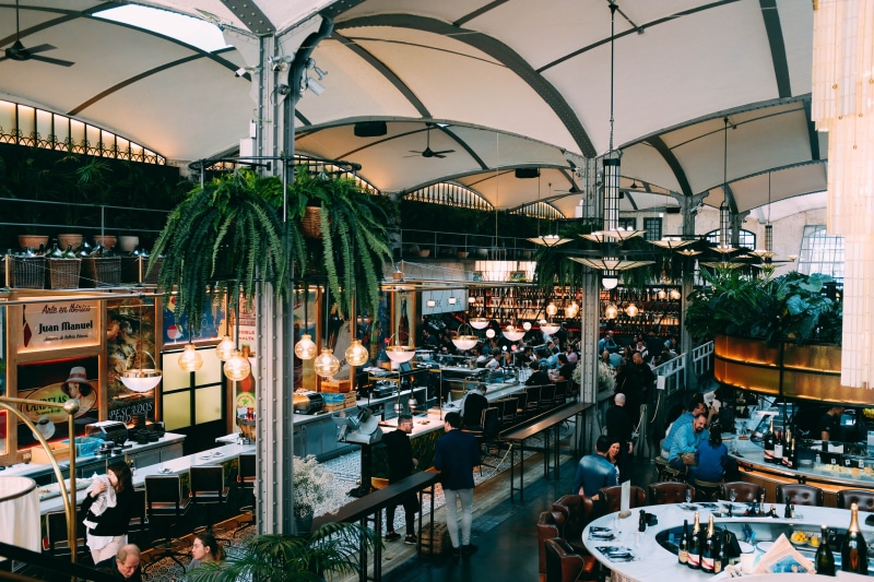 small business, urban, deli, meal, cafe, people, adult, illuminated, shopping, person, lighting equipment, restaurant, shop, cafeteria, pub, chair, food