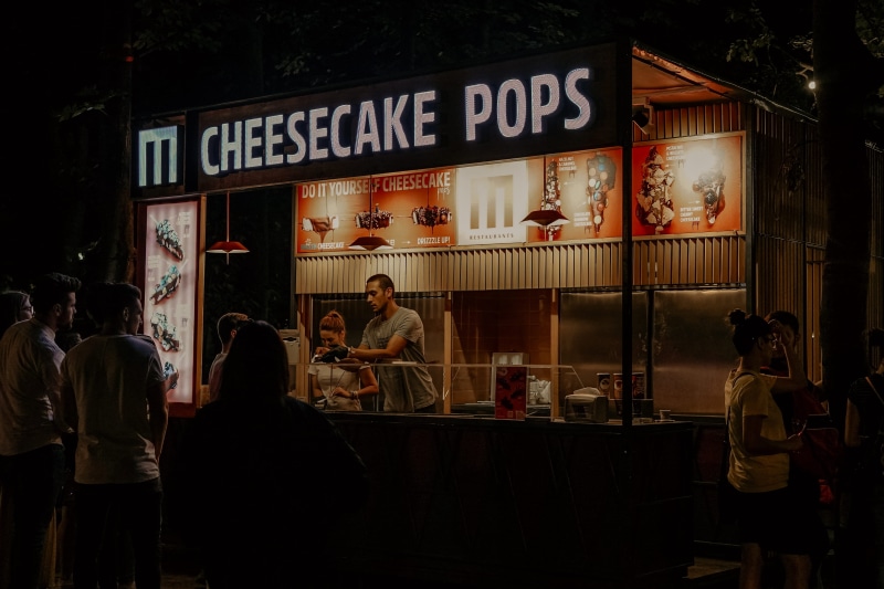 group of people, architecture, food and drink, men, restaurant, stall, text, shop, pub, person, furniture, night, shelf, illuminated, sign, kiosk, cafeteria