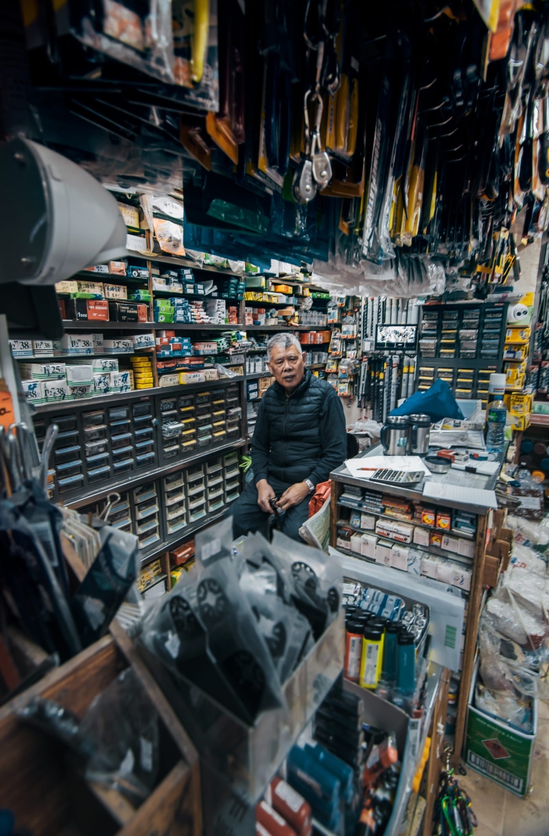 large group of objects, bazaar, one person, occupation, business, 4K, standing, person, shop, monitor, building, man, market, indoors, sitting, grocery store