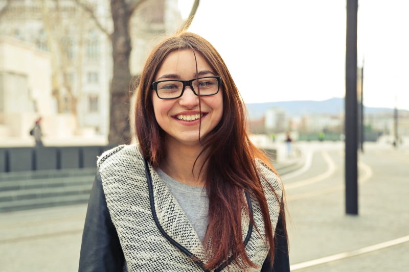 hairstyle, woman, travel, happiness, student, street, joy, young, outdoor, one woman only, smile, eyeglasses, looking at camera, 20-25 years, woolen black and white