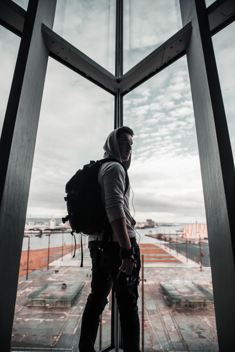 contemplation, apparel, nature, bag, gown, 5K, sliding door, cameraman, windows, glass, outdoors, men, lifestyles, fashion, backpack, sky, pants, day