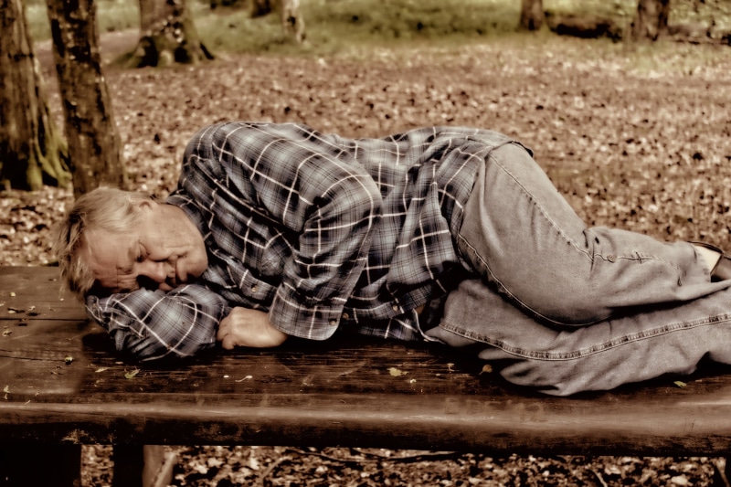 casual clothing, day, lifestyles, bench, lying down, human, men, brown, 1080P, tired, face, hopelessness, park bench, people, black, man, one Person, social issues