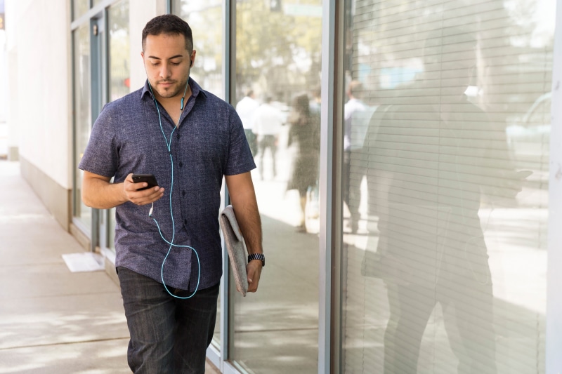 dayhtime, portable information device, one person, technology, sidewalk, street, near, shirt, sales pro, modern, smart phone, office, mobile phone, blue